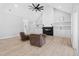 Bright living room showcasing a fireplace, built-in shelving, and plush seating with wood-look floors at 1429 Sagamore Dr, Louisburg, NC 27549