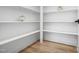 Walk-in pantry with multiple white shelves for ample storage at 1429 Sagamore Dr, Louisburg, NC 27549