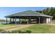 Community picnic shelter with tables and lake access on a sunny day at 1429 Sagamore Dr, Louisburg, NC 27549