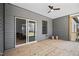 The open, covered porch has a wooden deck floor, ceiling fan, and sliding glass doors into the home at 1429 Sagamore Dr, Louisburg, NC 27549