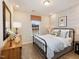 Comfortable bedroom with stylish wallpaper, a dark metal bed frame, and colorful window shade at 1505 Bright Coral Trl, Wendell, NC 27591
