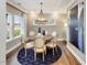 Well-lit dining area with a decorative chandelier, six chairs, a round table, and a large rug at 1505 Bright Coral Trl, Wendell, NC 27591