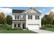 Charming two-story home with a symmetrical facade, attached garage, and well-maintained landscaping at 1505 Bright Coral Trl, Wendell, NC 27591