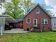 Backyard view of a brick home with a covered parking area at 1522 W Thomas St, Rocky Mount, NC 27804