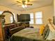 Bedroom with decorative mirror, ceiling fan, and a large window at 1522 W Thomas St, Rocky Mount, NC 27804