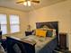 Bedroom with dark wood furniture, neutral walls, a ceiling fan, and large windows at 1522 W Thomas St, Rocky Mount, NC 27804