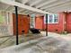 Spacious carport with black support beams, adjacent to the brick house at 1522 W Thomas St, Rocky Mount, NC 27804