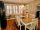 Elegant dining room with a chandelier, hardwood floors, and built-in shelving at 1522 W Thomas St, Rocky Mount, NC 27804