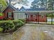 Exterior of home with carport, lush landscaping, and ample parking at 1522 W Thomas St, Rocky Mount, NC 27804