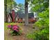 Traditional brick home with a chimney, flowering shrubs, and a landscaped yard at 1522 W Thomas St, Rocky Mount, NC 27804