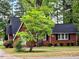 Charming brick home with a well-manicured lawn and mature trees at 1522 W Thomas St, Rocky Mount, NC 27804