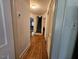 Hallway leading to the stairwell with hardwood flooring and neutral paint at 1522 W Thomas St, Rocky Mount, NC 27804
