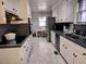 Kitchen with white cabinets, stainless appliances, tile floors, and adjacent dining area at 1522 W Thomas St, Rocky Mount, NC 27804