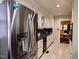 Galley kitchen with stainless steel appliances, light cabinetry, and tile flooring at 1522 W Thomas St, Rocky Mount, NC 27804