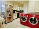 The kitchen has an adjacent laundry area with stacked red front load machines at 1522 W Thomas St, Rocky Mount, NC 27804