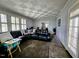 Spacious living room featuring a leather sectional sofa, large windows, and checkerboard ceiling at 1522 W Thomas St, Rocky Mount, NC 27804