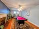 A bright living room with a fireplace, pool table, and plenty of natural light at 1522 W Thomas St, Rocky Mount, NC 27804