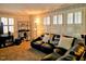 Cozy living room with a leather sectional sofa, shelving, and window with plantation shutters at 1522 W Thomas St, Rocky Mount, NC 27804