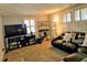 Cozy living room features a leather sectional sofa, shelving, and window with plantation shutters at 1522 W Thomas St, Rocky Mount, NC 27804