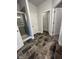 Bathroom featuring gray tile flooring, a glass-door shower, and a doorway to another bathroom area at 1579 Pecan Drive # 29, Nashville, NC 27856