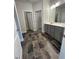 Bathroom with double vanity, gray cabinets, tile flooring, and separate toilet and shower rooms at 1579 Pecan Drive # 29, Nashville, NC 27856
