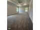 Spacious bedroom featuring plush carpeting, a tray ceiling with fan, and lots of natural light at 1579 Pecan Drive # 29, Nashville, NC 27856