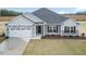 Charming single-story home featuring stone accents, a two-car garage, and a well-manicured lawn at 1579 Pecan Drive # 29, Nashville, NC 27856