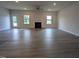 Spacious living room features a fireplace, ceiling fan, and luxury vinyl flooring at 1579 Pecan Drive # 29, Nashville, NC 27856
