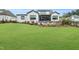 Expansive backyard features lush green lawn, a screened porch, and thoughtful landscaping around the patio area at 1801 Clifton Pines Dr, Cary, NC 27519