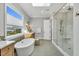 Bathroom featuring a walk-in shower, soaking tub, and herringbone tile flooring at 1801 Clifton Pines Dr, Cary, NC 27519