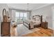 Serene bedroom with a large window, neutral decor, and hardwood floors at 1801 Clifton Pines Dr, Cary, NC 27519