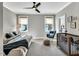 Bright bedroom with neutral paint, a ceiling fan, large windows and a combination crib and daybed at 1801 Clifton Pines Dr, Cary, NC 27519