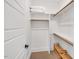 Bright walk-in closet with wooden shelves and plenty of space for storage and organization at 1801 Clifton Pines Dr, Cary, NC 27519