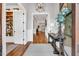 Elegant foyer showcasing hardwood floors, a console table with decor, and an arched doorway leading to the living area at 1801 Clifton Pines Dr, Cary, NC 27519