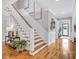 Elegant foyer with hardwood floors, staircase, and bright natural light at 1801 Clifton Pines Dr, Cary, NC 27519