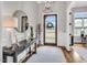 Stylish foyer featuring a round mirror, a console table, and a view of the front door with a decorative wreath at 1801 Clifton Pines Dr, Cary, NC 27519