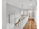 Upstairs hallway with hardwood floors, white railings, and neutral color palette at 1801 Clifton Pines Dr, Cary, NC 27519