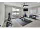 Home gym featuring a ceiling fan, mirrored wall, and workout equipment at 1801 Clifton Pines Dr, Cary, NC 27519