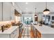Bright, open kitchen featuring a large island, stainless steel appliances, and hardwood floors at 1801 Clifton Pines Dr, Cary, NC 27519