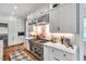 Well-equipped kitchen with stainless steel appliances, white cabinets, and diamond pattern rug at 1801 Clifton Pines Dr, Cary, NC 27519