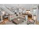 Open-concept living area with a large sofa, fireplace, and seamless flow to the kitchen at 1801 Clifton Pines Dr, Cary, NC 27519