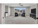 Spacious living room featuring a ceiling fan, wet bar and large windows offering plenty of natural light at 1801 Clifton Pines Dr, Cary, NC 27519