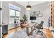 Bright office with hardwood floors, a modern desk setup, built-in bookshelves, and a comfortable seating area at 1801 Clifton Pines Dr, Cary, NC 27519
