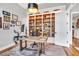 Well-appointed office with hardwood floors, a spacious desk, a comfortable chair, and a large built-in bookcase at 1801 Clifton Pines Dr, Cary, NC 27519