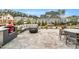 Stone patio featuring an outdoor grill, a sectional sofa, fire pit and dining space at 1801 Clifton Pines Dr, Cary, NC 27519