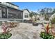 Beautiful outdoor stone patio including a kitchen, fire pit, and screened porch for relaxing and entertaining at 1801 Clifton Pines Dr, Cary, NC 27519