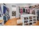 Spacious walk-in closet with ample shelving, hanging racks, and central island at 1801 Clifton Pines Dr, Cary, NC 27519