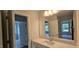 Bright bathroom featuring large mirror, quartz countertop, and access to additional rooms at 20 Bold Dr, Youngsville, NC 27596