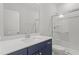 Bathroom featuring single vanity, white countertop, blue cabinets and walk-in shower at 20 Bold Dr, Youngsville, NC 27596