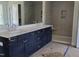 Bathroom with a double vanity, modern cabinetry, and a tiled shower at 20 Bold Dr, Youngsville, NC 27596